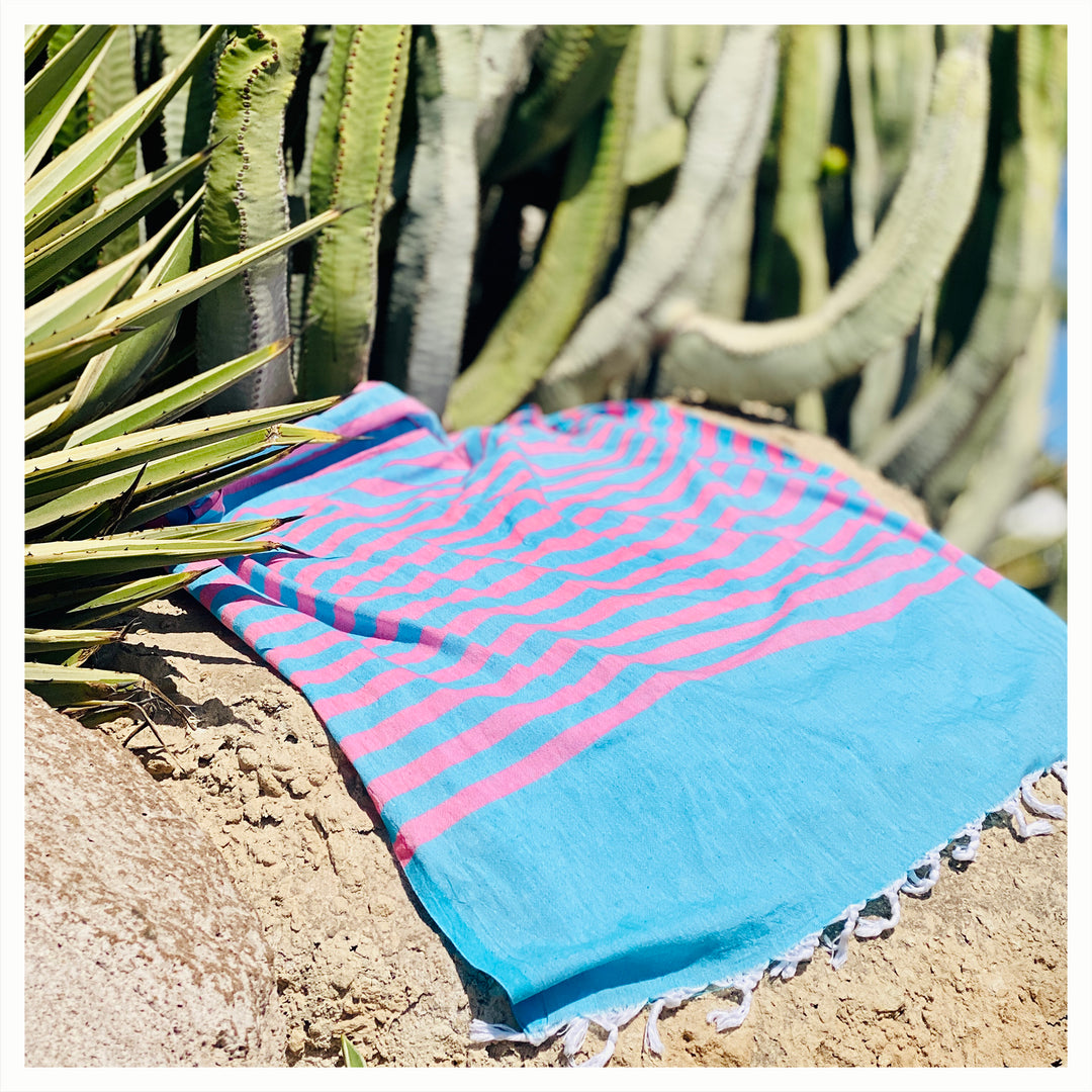 clara hammam towel on sand next to cactus