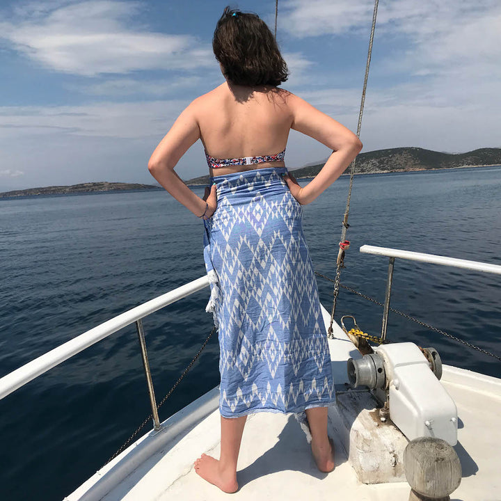 girl on deck wearing blue hammam towel