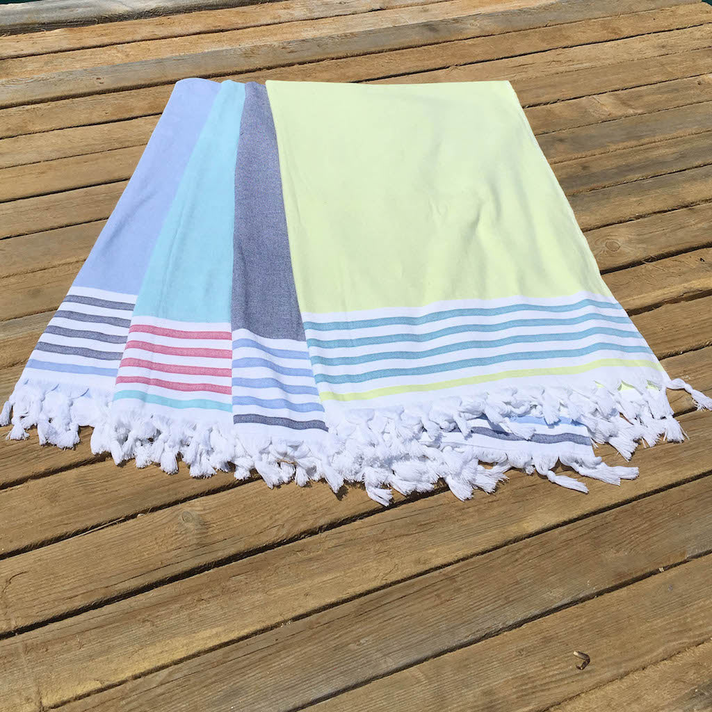 dina beach towels laid out on decking