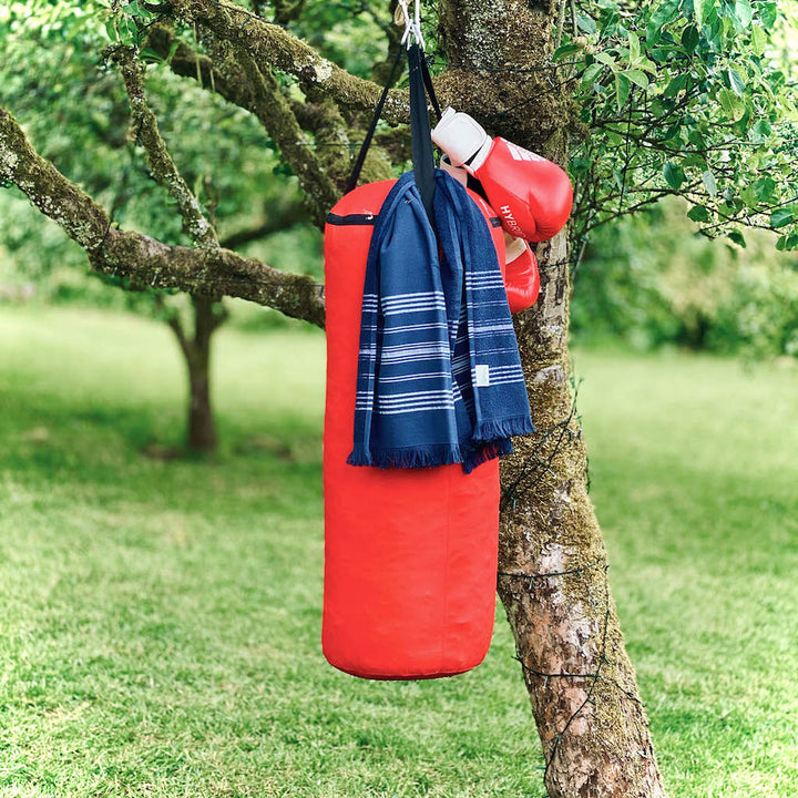 small navy dina terry backed towel on punchbag in garden