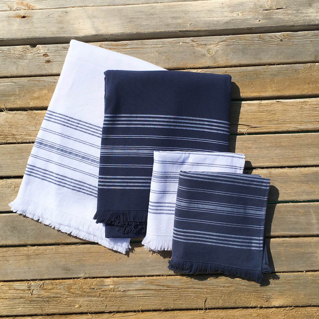 white and navy dina terry backed towels on decking