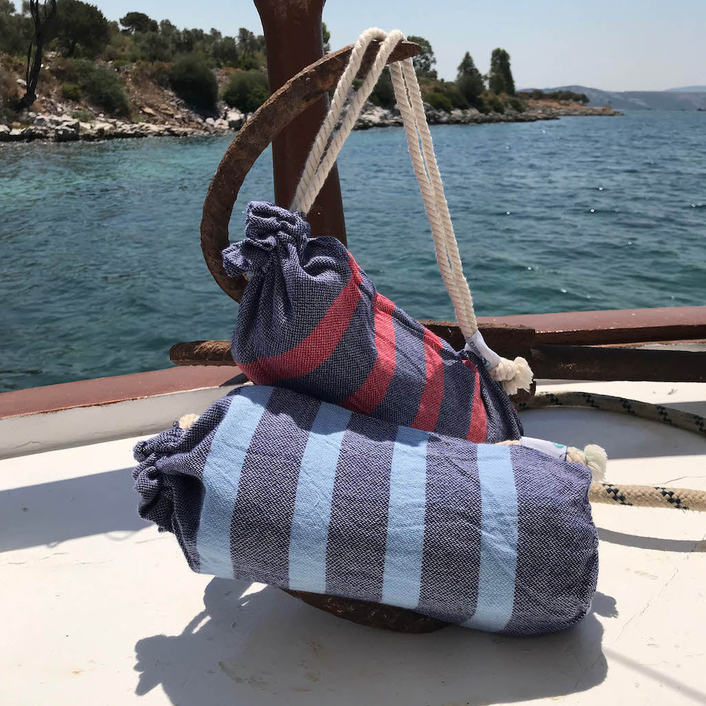 felix hammam towels in bags displayed on ship's deck 