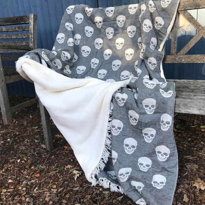 skull fleece lined throw opened out on bench outside